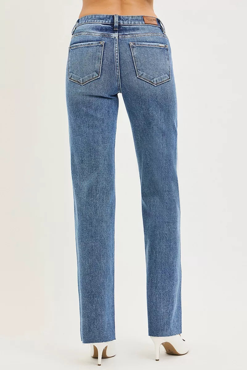 Back view of RISEN Tummy Control 4 Way Stretch Mid Rise Straight Jeans in blue denim with classic pockets