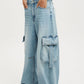 Vintage wash wide leg cargo jeans in light-wash denim with flap pockets
