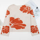 Boho oversized knit sweater for women with beige base and bold orange floral patterns