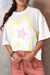 White oversized drop shoulder tee with layered star graphic in yellow and pink
