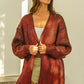 Cozy oversized red black textured knit V-neck cardigan with ribbed hem
