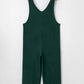 Dark green womens v-neck sleeveless corduroy jumpsuit on hanger
