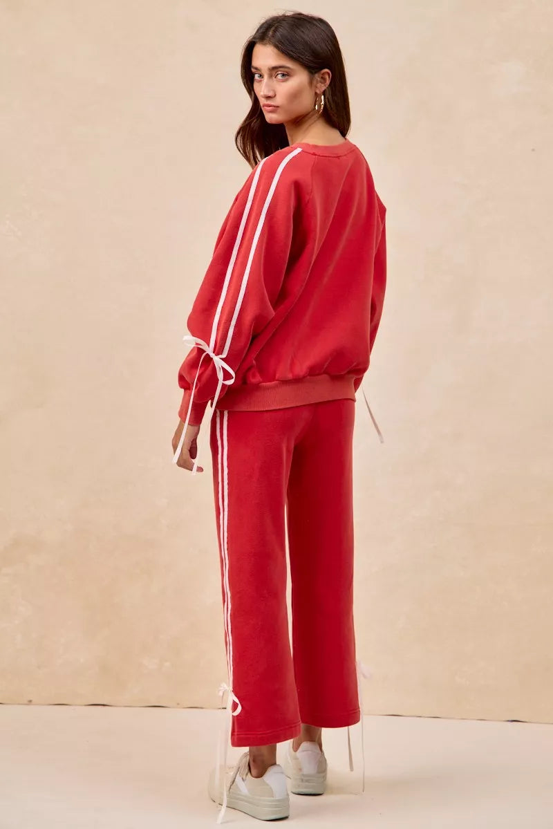 BiBi red fleece sweatpants with white side stripes and bow details