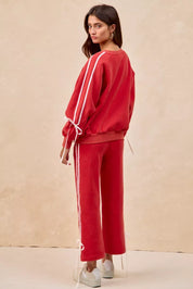 BiBi red fleece sweatpants with white side stripes and bow details