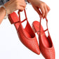 Vibrant coral-red woven leather slingback flats with pointed toe