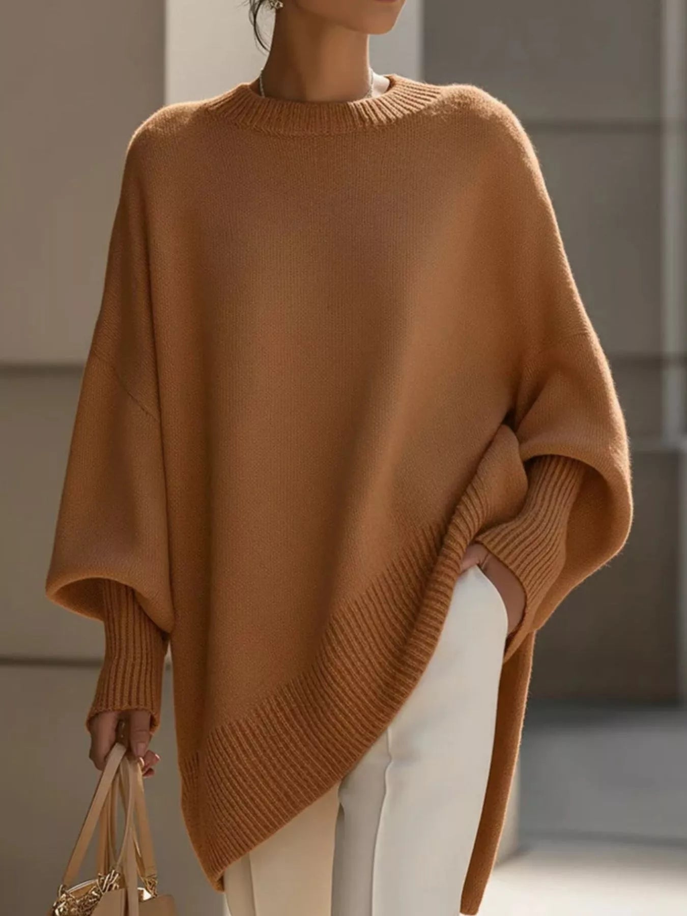 Cozy camel-colored oversized batwing sleeve knit poncho with ribbed cuffs