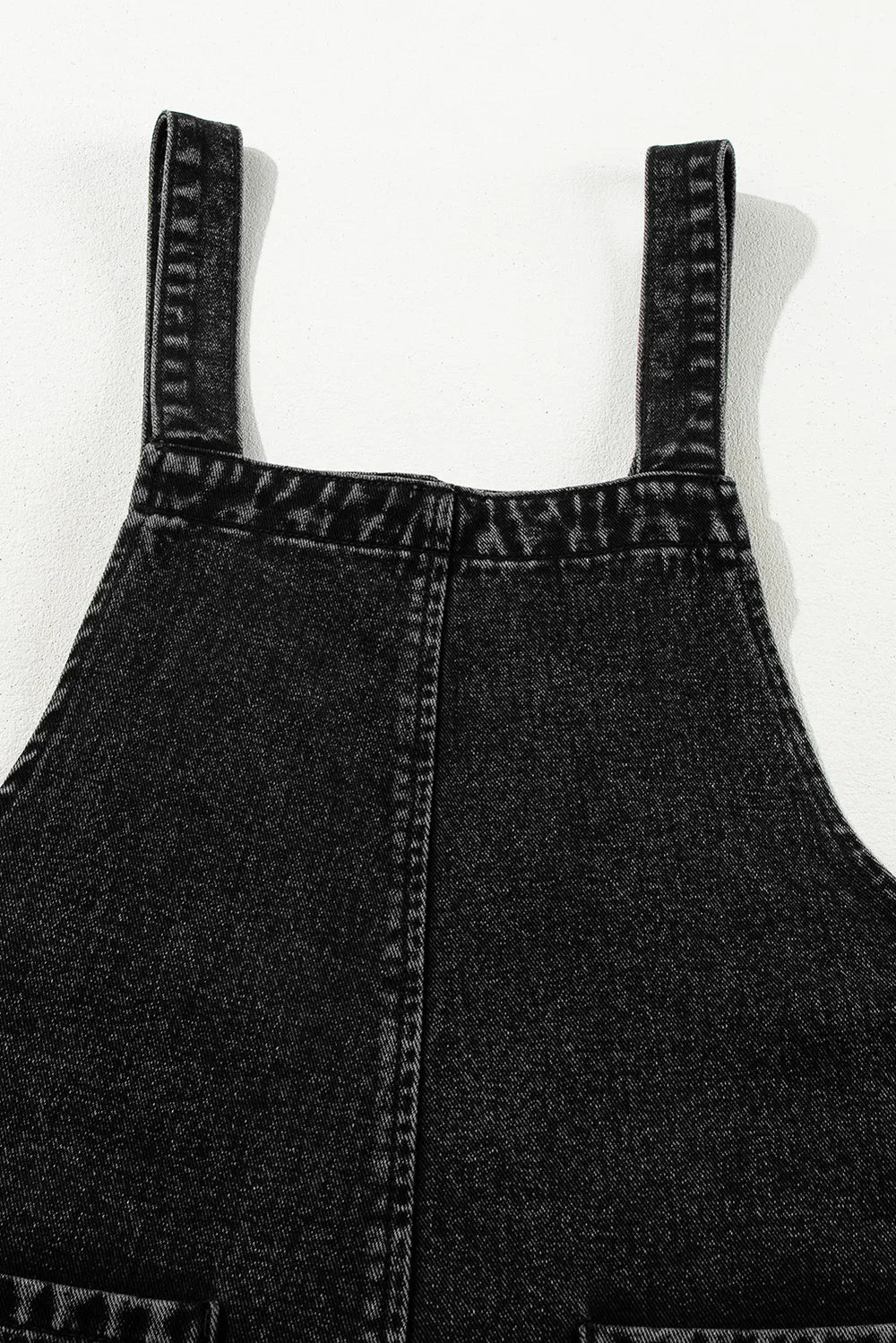 Distressed wide strap denim overalls with reinforced straps and visible stitching