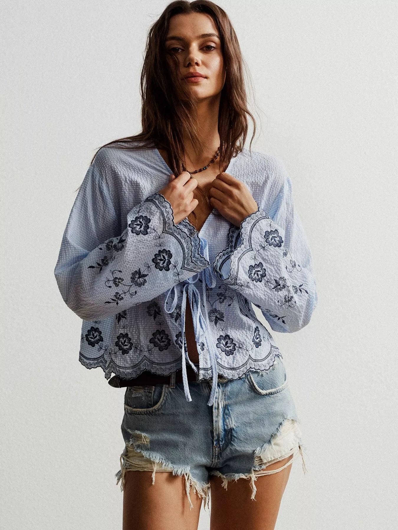 Floral embroidered tie-front blouse in blue and white with lace details