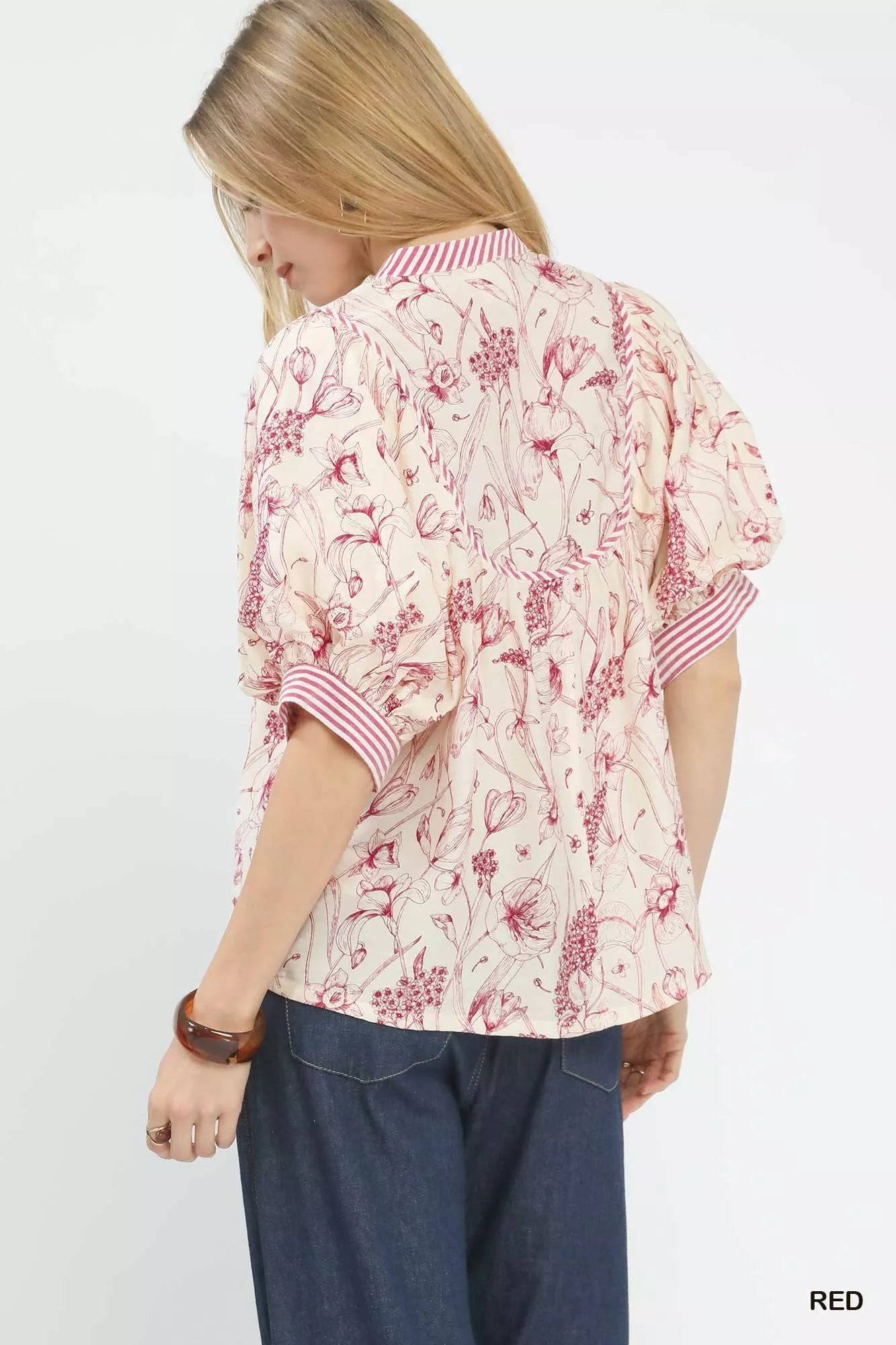 Woman in Umgee mixed print puff sleeve split neck top with pink floral blouse