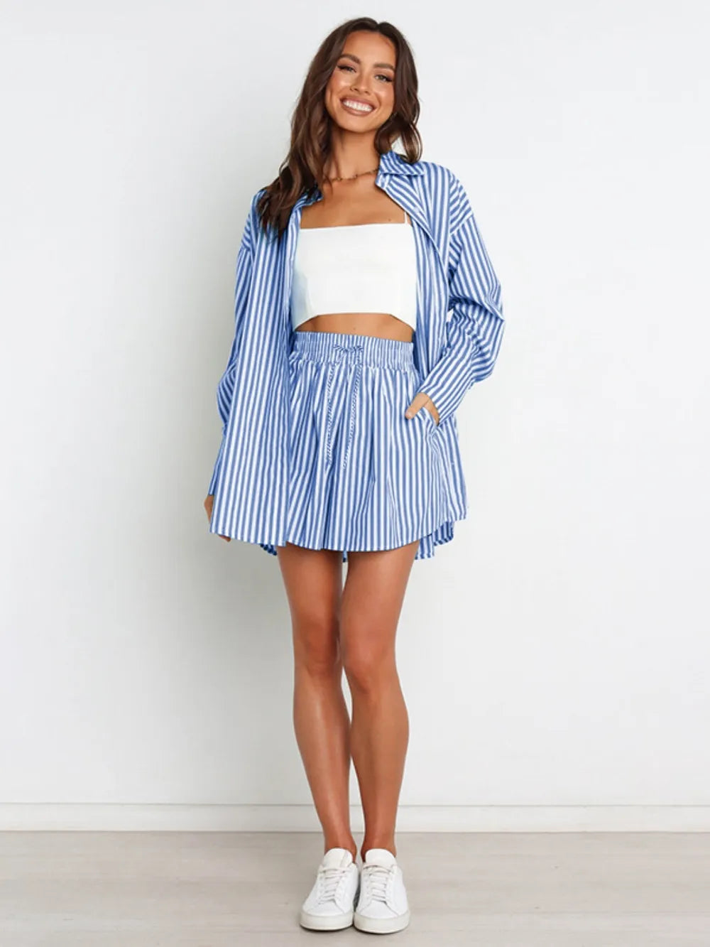 Blue and white striped oversized button-down shirt open over white crop top