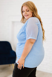 Plus size light blue striped V-neck raglan sleeve tee with black leggings