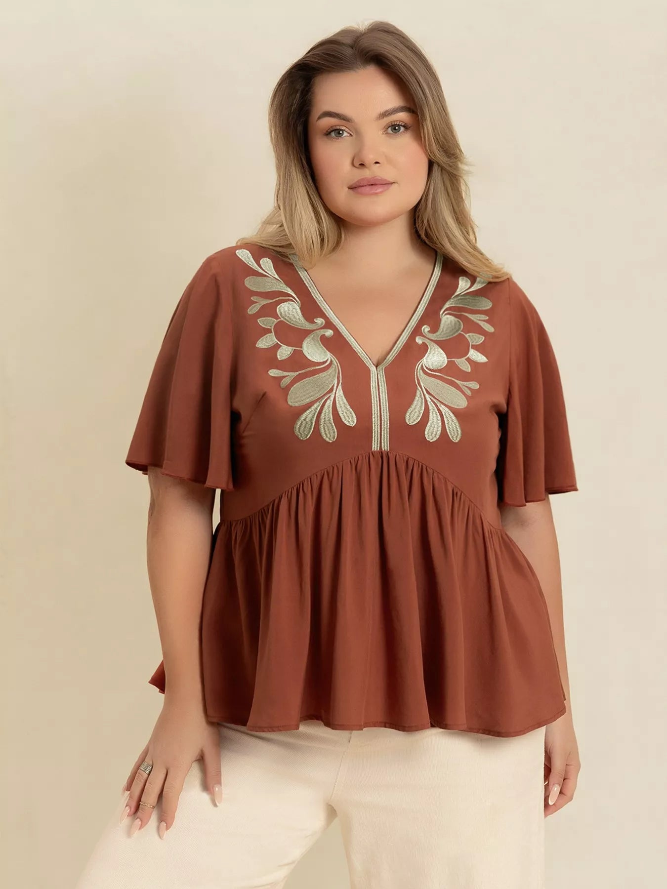 Plus size embroidered V-neck flutter sleeve blouse in rust with silver leaf details