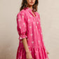 Vibrant pink BiBi ribbon pattern dress with white bows, puffed sleeves, tiered skirt, scallop edges
