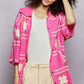 Vibrant pink crochet cardigan with white floral granny square patterns