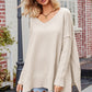Cream-colored oversized V-neck ribbed long sleeve sweater