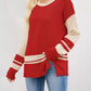 Red and cream color-blocked knit sweater with side slits and ribbed trim