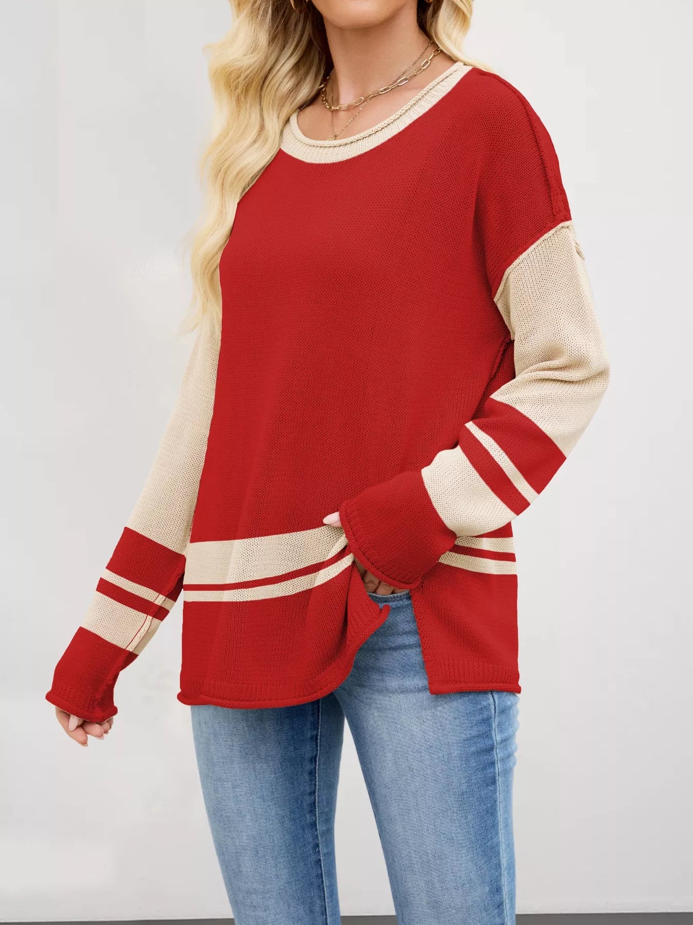 Red and cream color-blocked knit sweater with side slits and ribbed trim