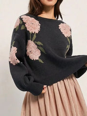 Black floral boat neck long sleeve sweater with pink flowers and green leaves