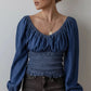 Blue denim blouse with puffed sleeves and smocked waist
