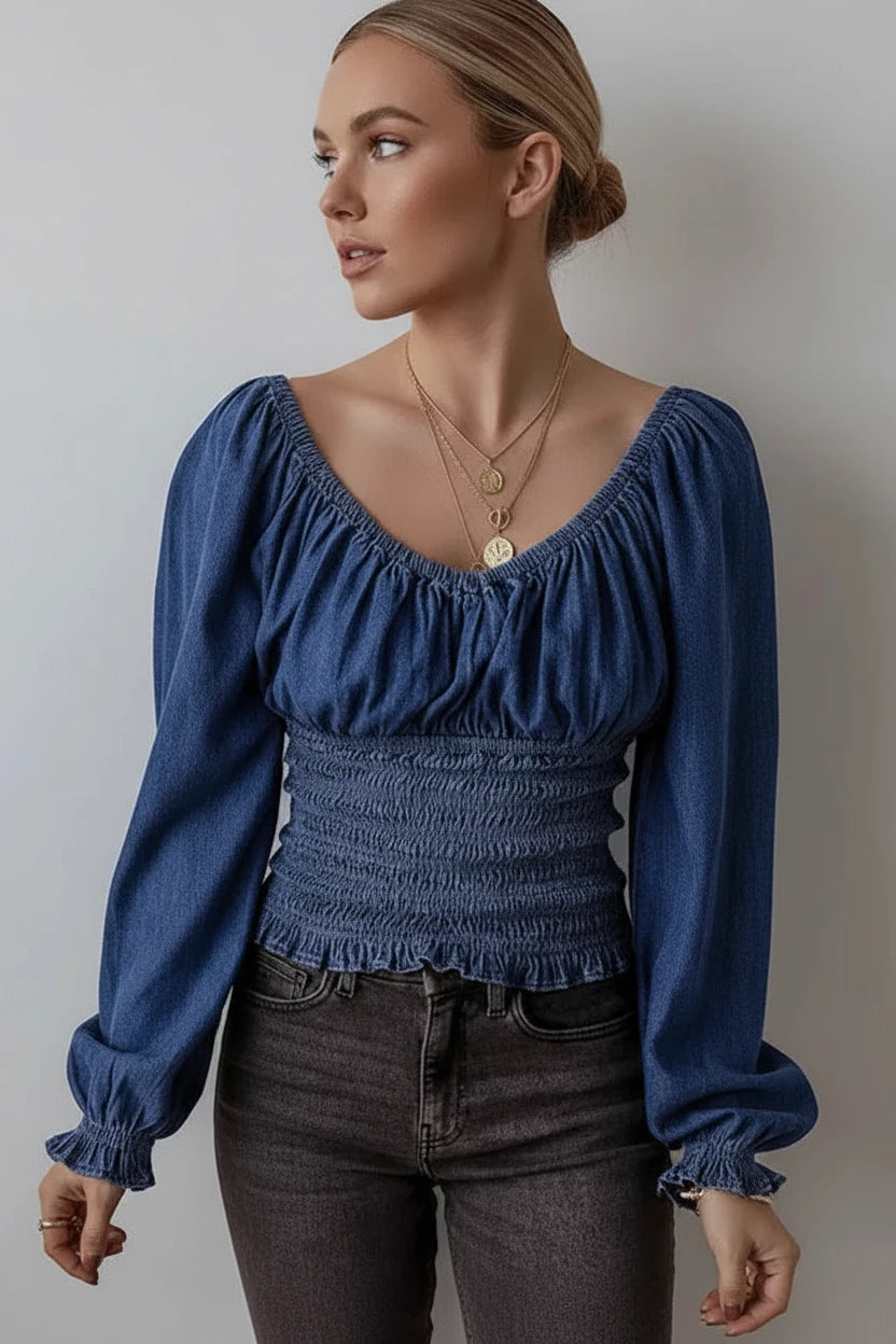 Blue denim blouse with puffed sleeves and smocked waist