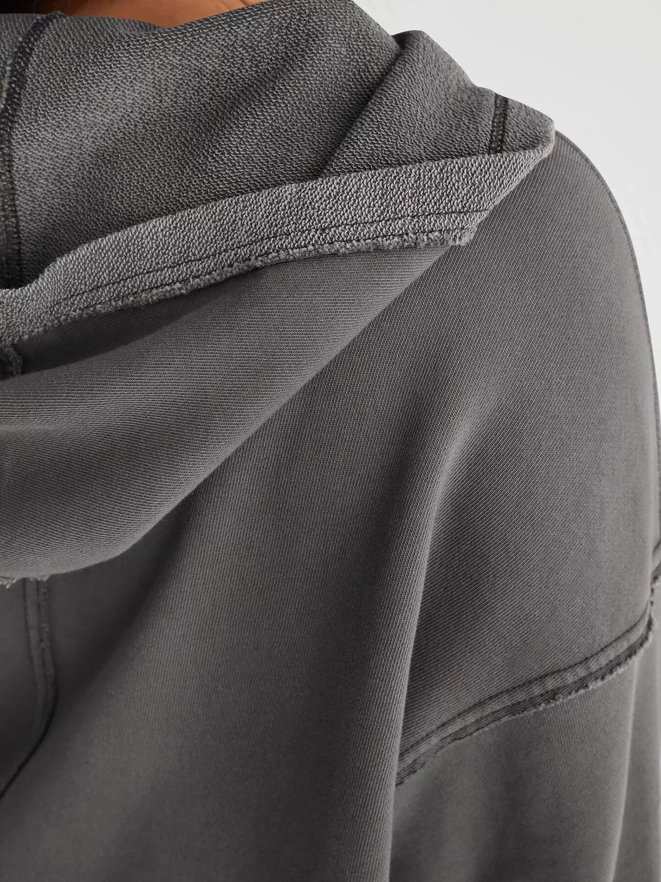 Exposed Seam Dropped Shoulder Hoodie in soft dark gray textured fabric