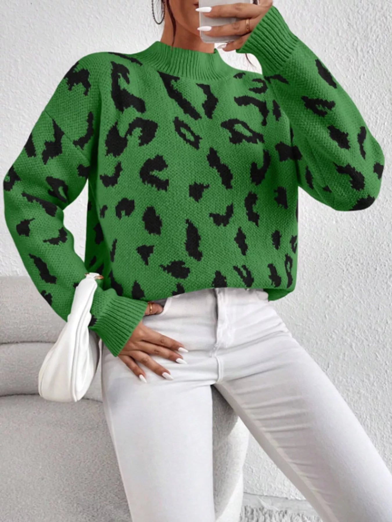 Green leopard print mock neck sweater with white pants and water glass