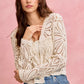 Cream-colored crochet knit long sleeve cardigan with floral lace patterns