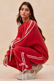 Red adidas Originals velour tracksuit with white stripes and bow details