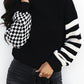 Black turtleneck sweater with checkered and striped knit sleeves