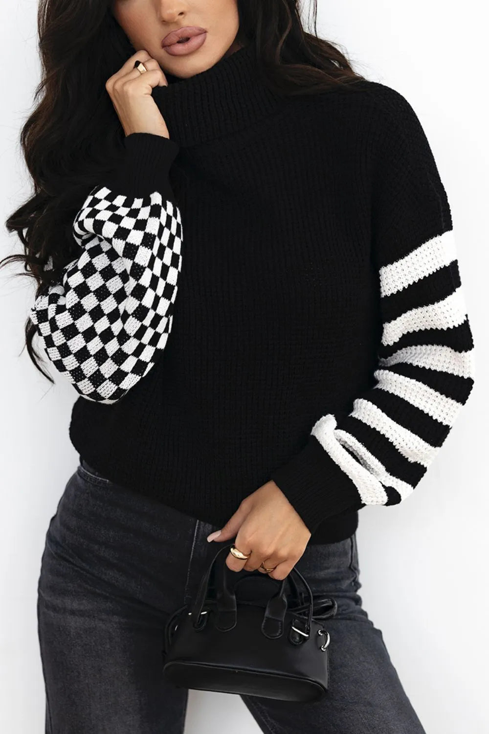 Black turtleneck sweater with checkered and striped knit sleeves