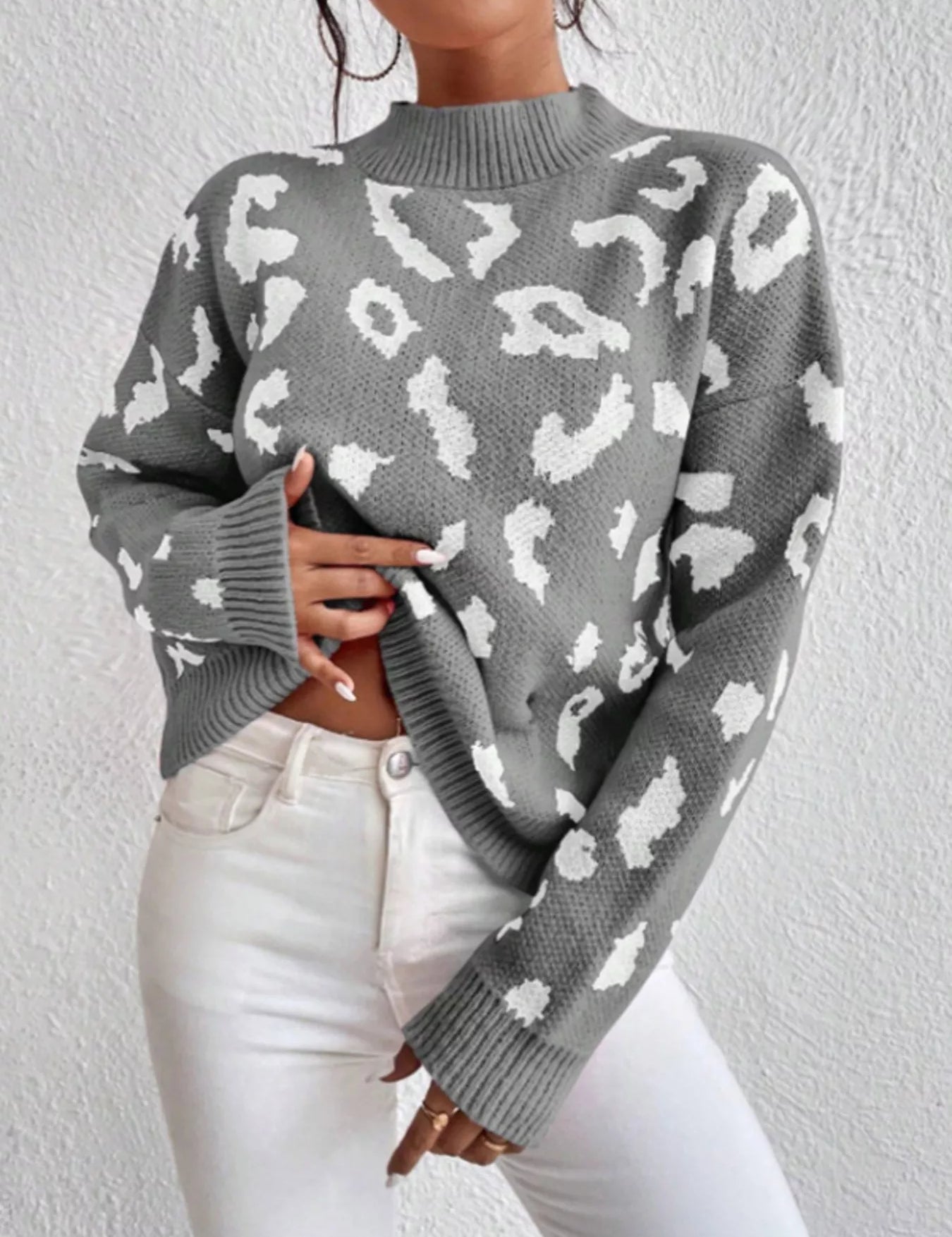 Leopard mock neck sweater with long sleeves and ribbed cuffs on gray background