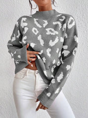 Leopard mock neck sweater with long sleeves and ribbed cuffs on gray background