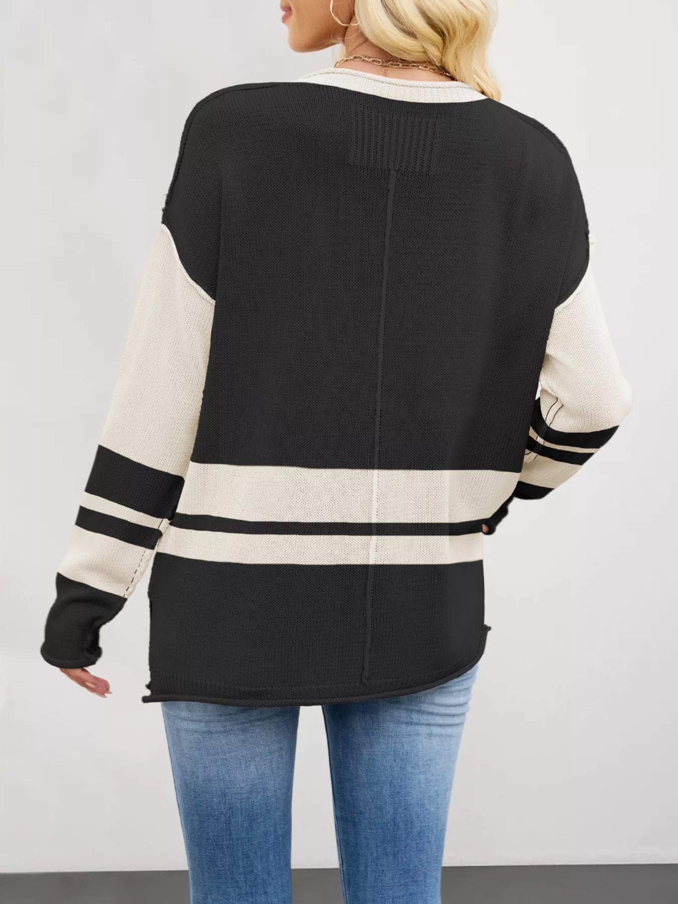 Black and cream color block side slit knit sweater with striped sleeves