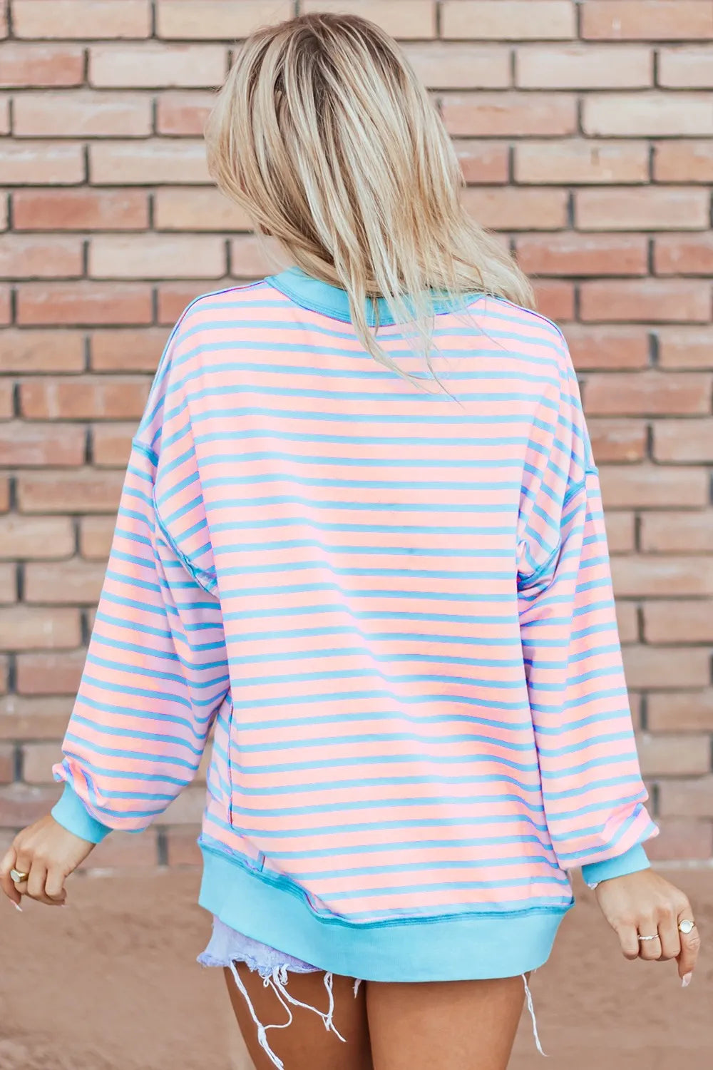 Pastel pink and light blue striped high-low sweatshirt with turquoise trim
