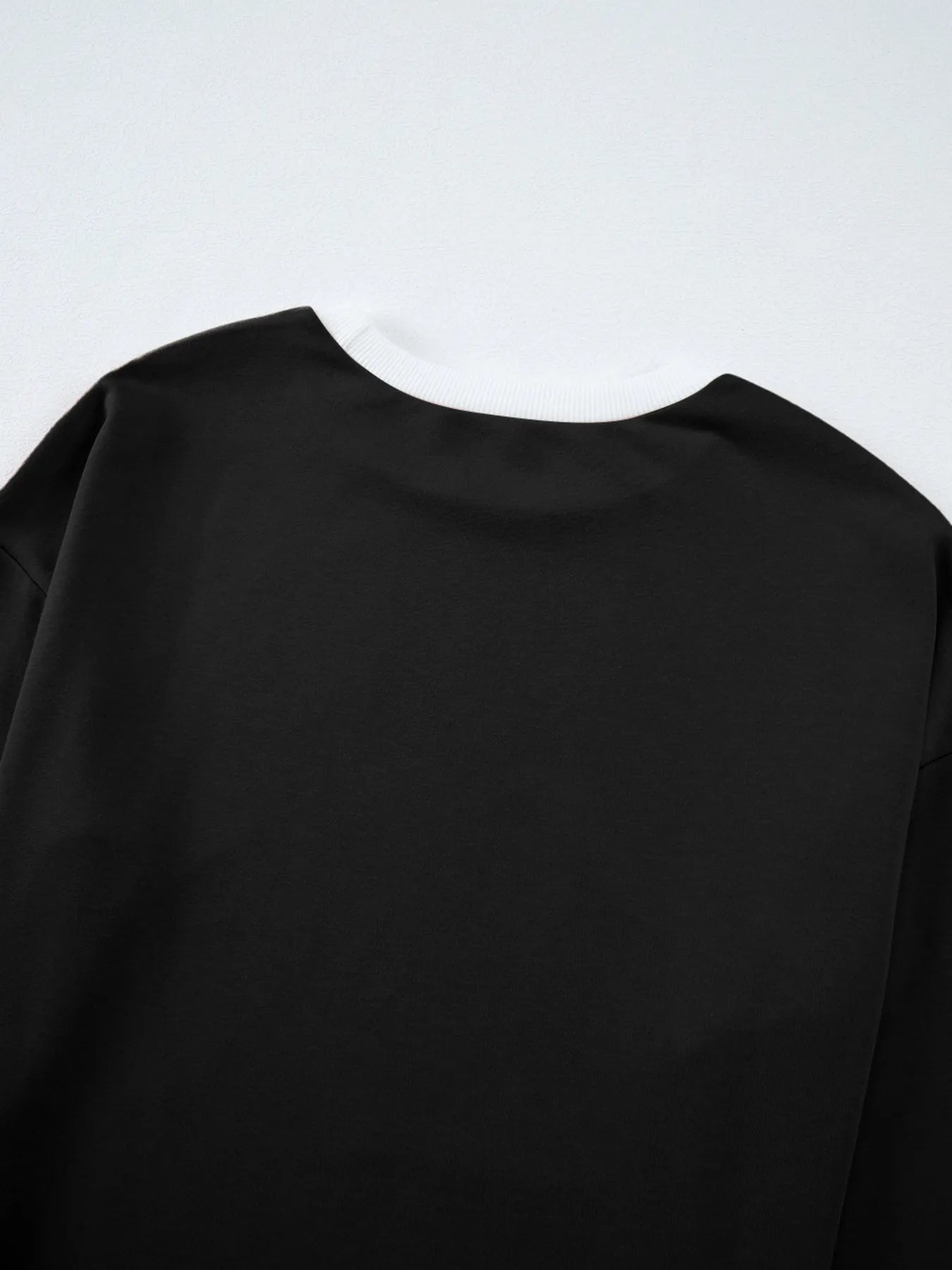 Black long-sleeved Daverri Fashions round neck top with ribbed cuffs