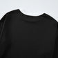 Black long-sleeved Daverri Fashions round neck top with ribbed cuffs