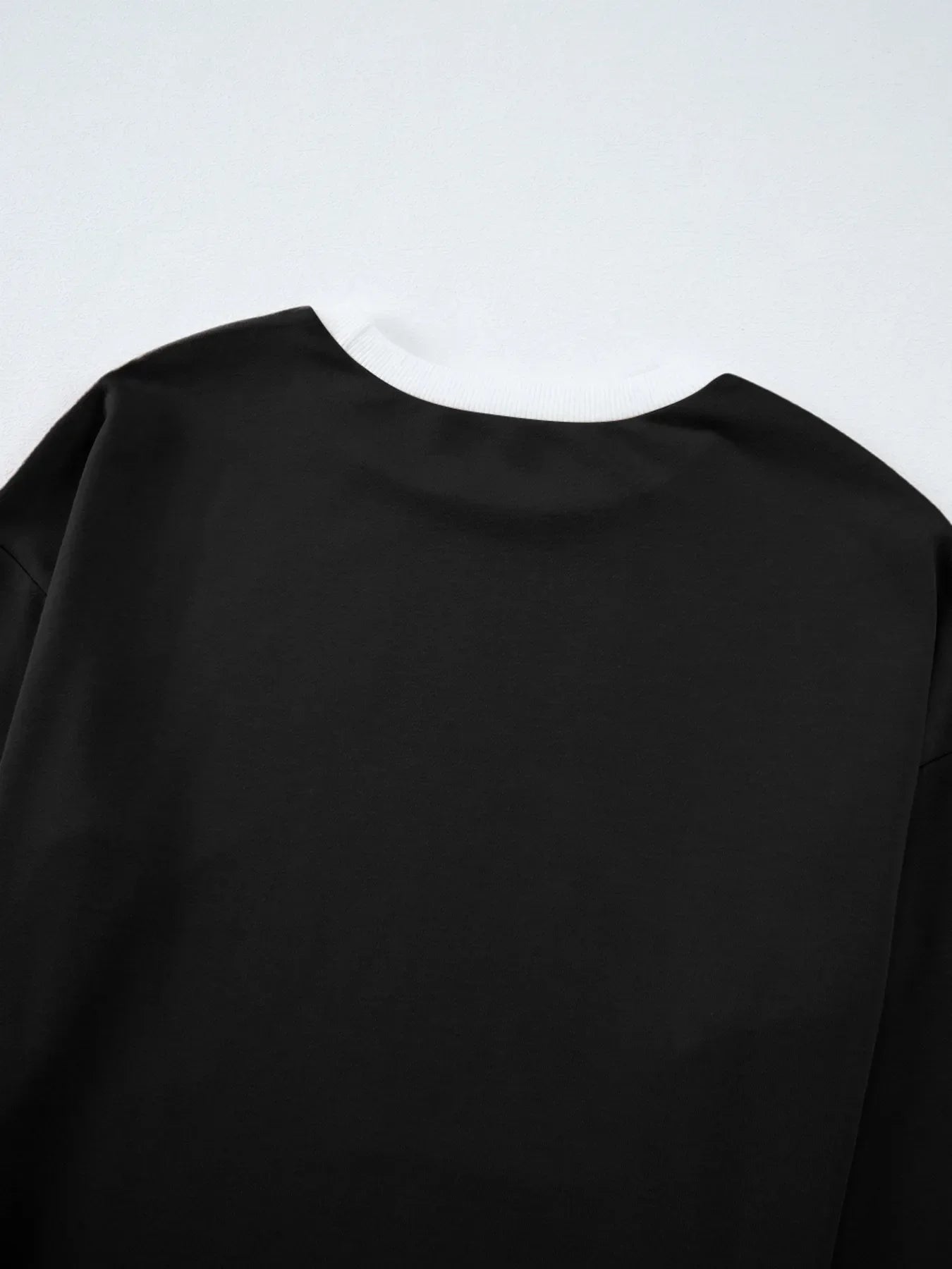 Black long-sleeved Daverri Fashions round neck top with ribbed cuffs