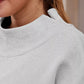 Light gray heathered mock neck dropped shoulder sweatshirt with ribbed crew neckline