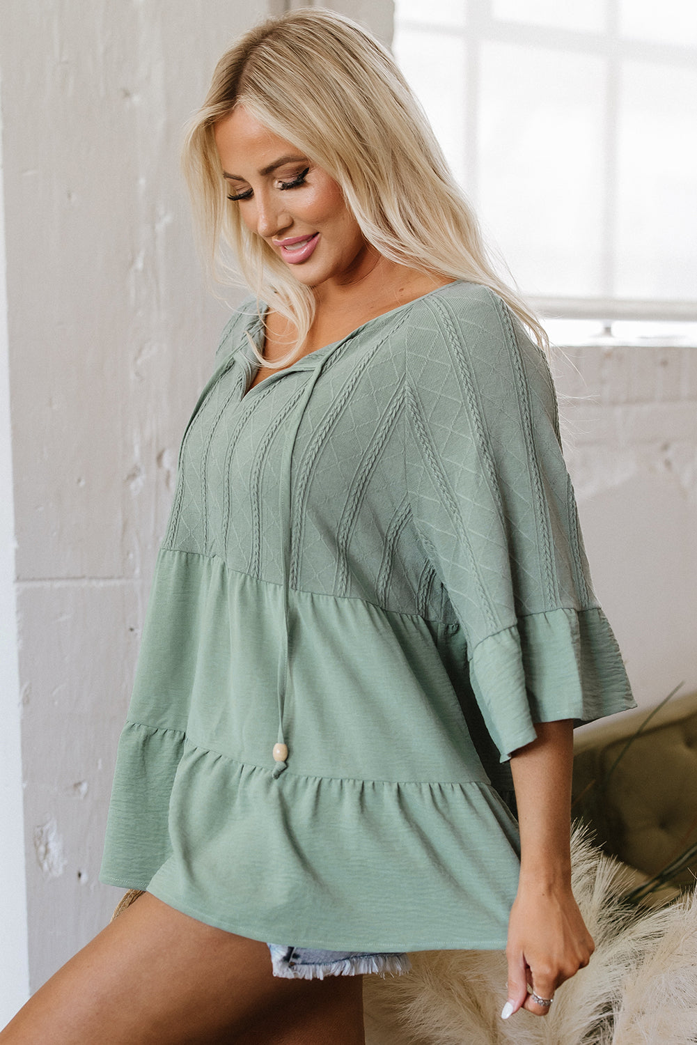 Soft sage green Laurel Green textured ruffle patchwork blouse with v-neck and tie split