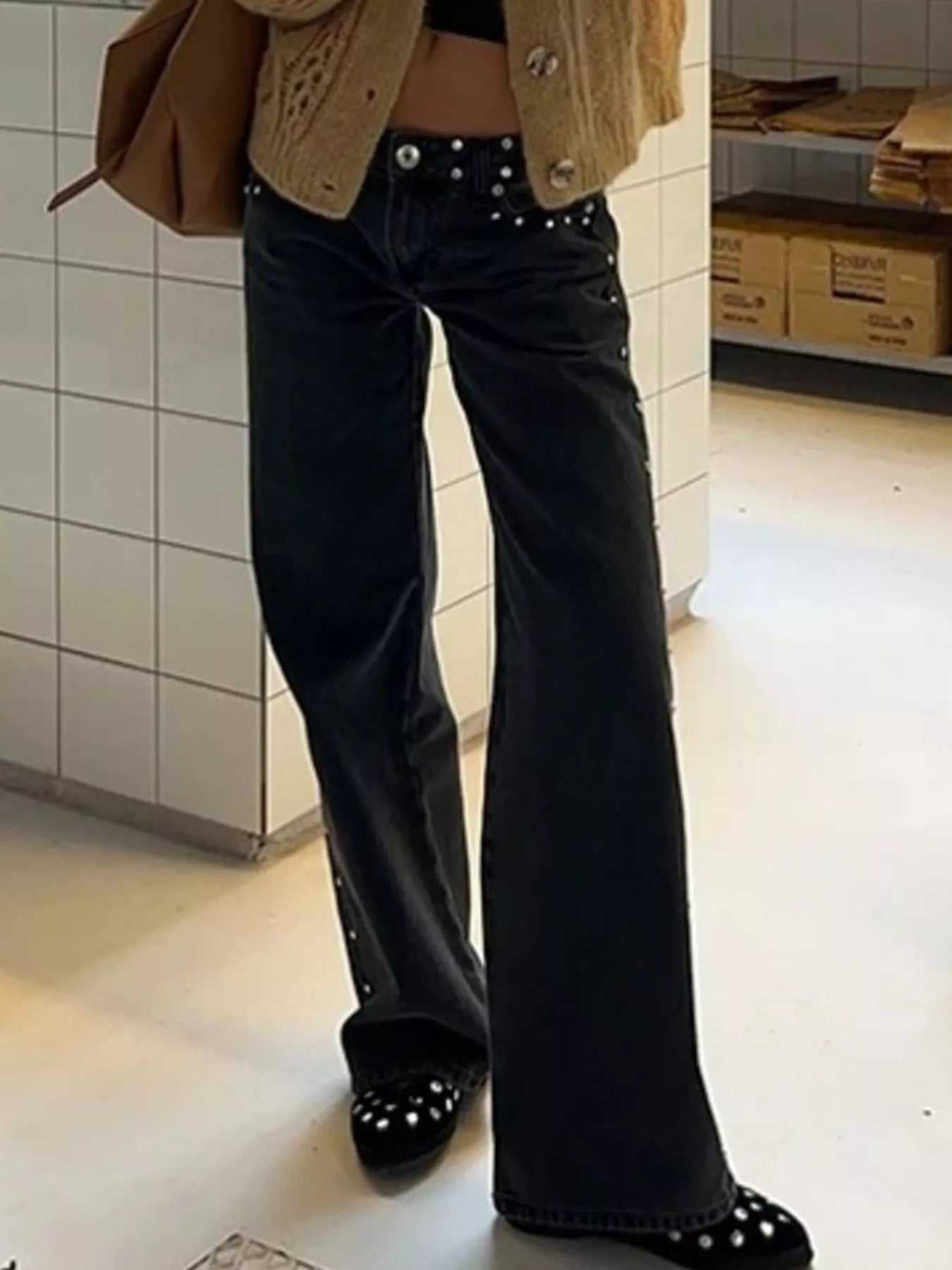 Black flared denim jeans with silver studs and leopard star patches