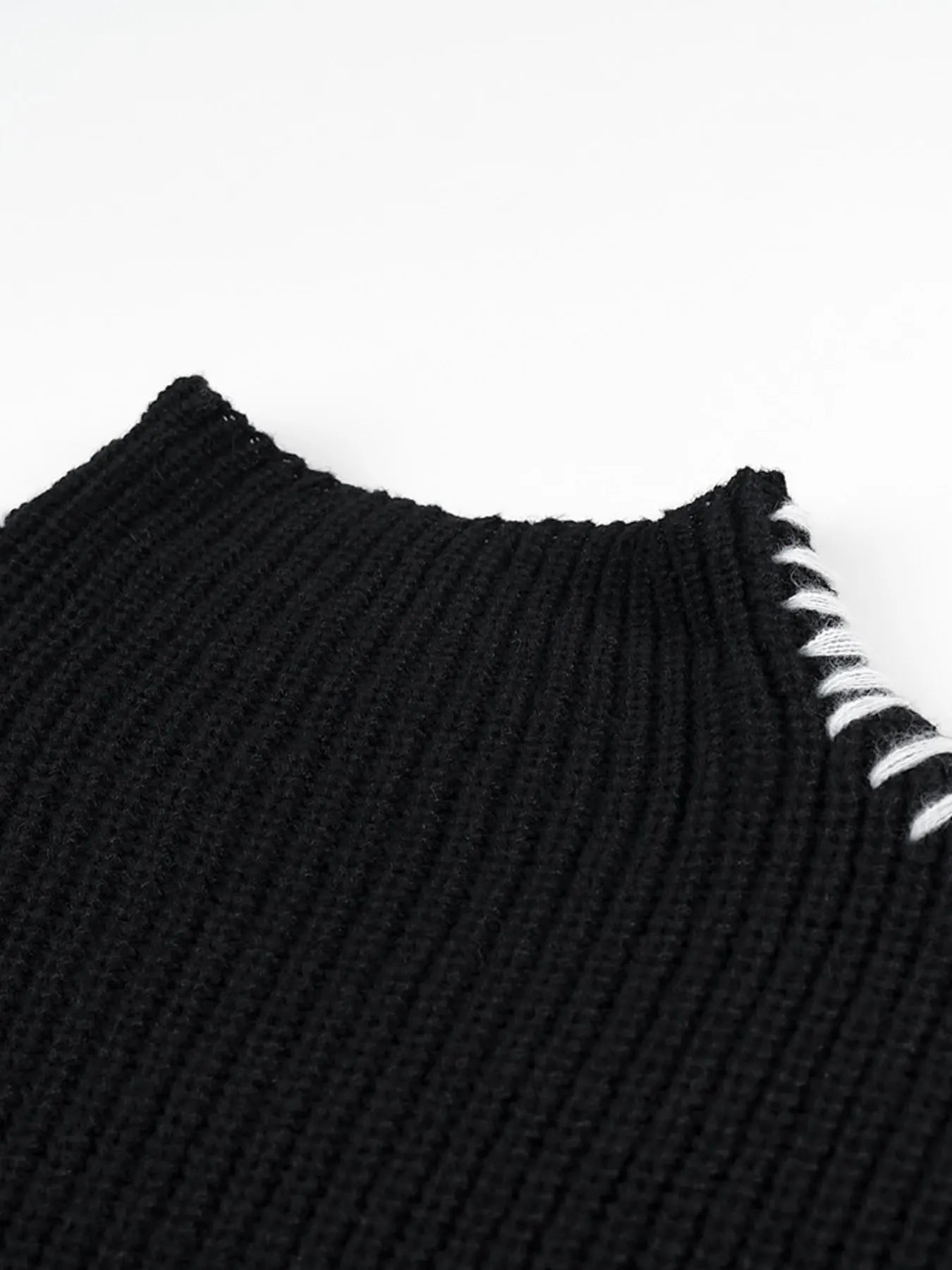 Black ribbed knit sweater with white contrast stitch mock neck