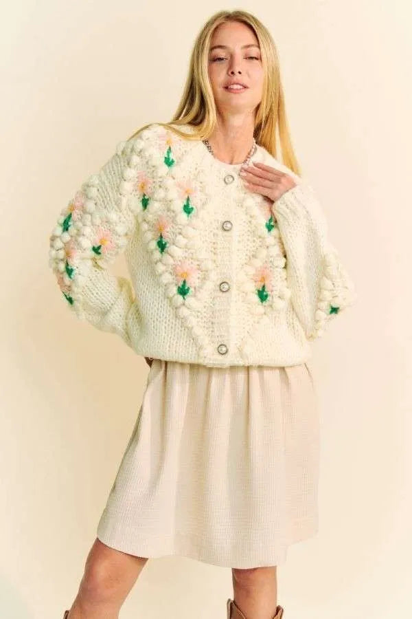 Cream-colored knit Davi & Dani cardigan with pink and green pom-pom floral embroidery