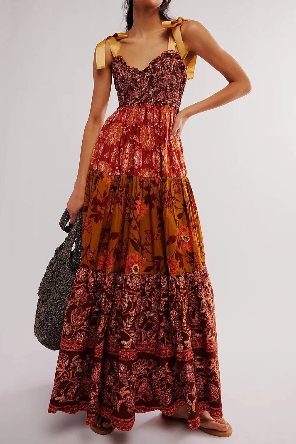 Floral tiered maxi dress in rust mustard tones with gold ribbon ties