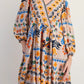 Vibrant bohemian floral print long sleeve mini dress in beige with orange, blue, green, black patterns