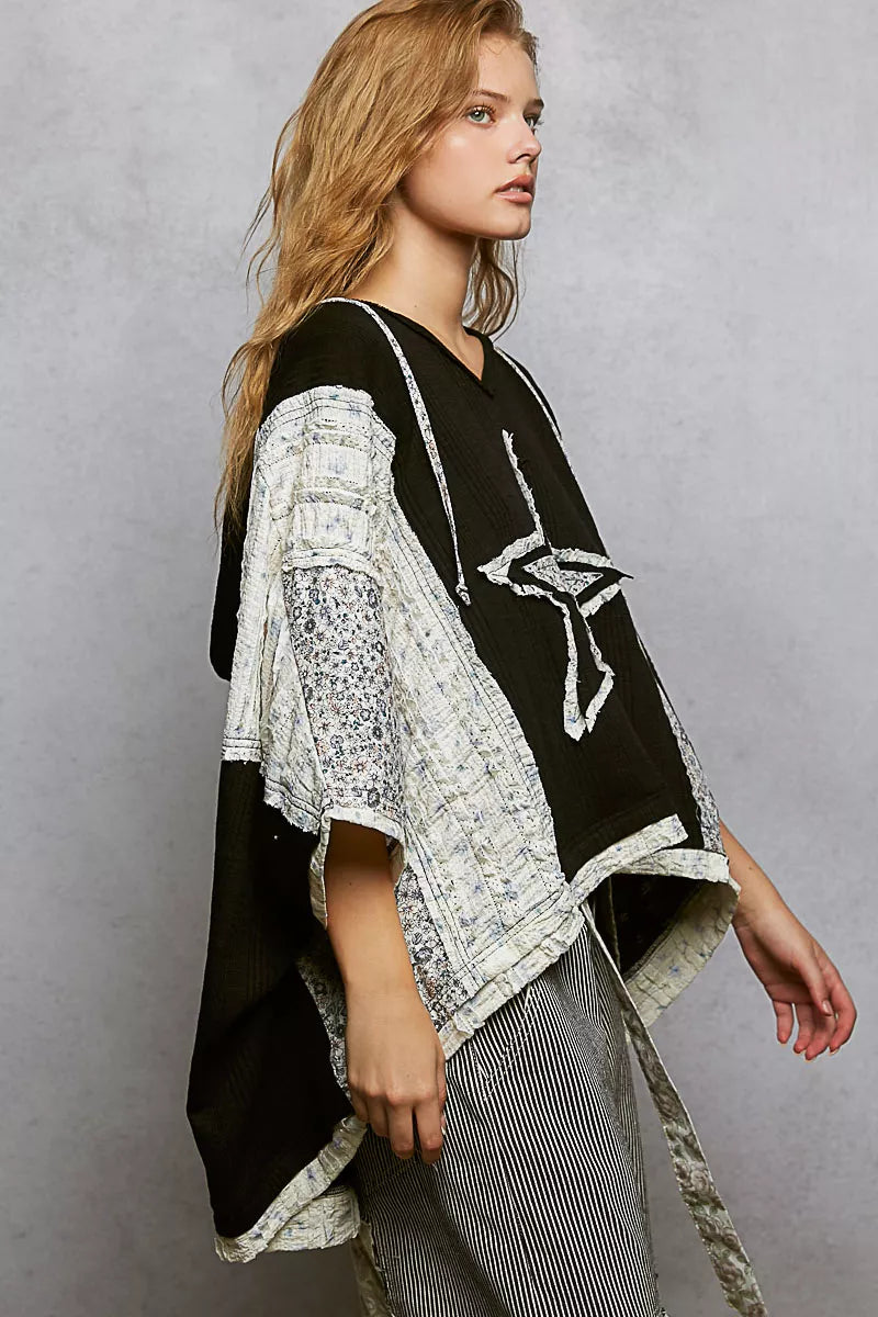 Black and white floral star patch hooded poncho with lace details