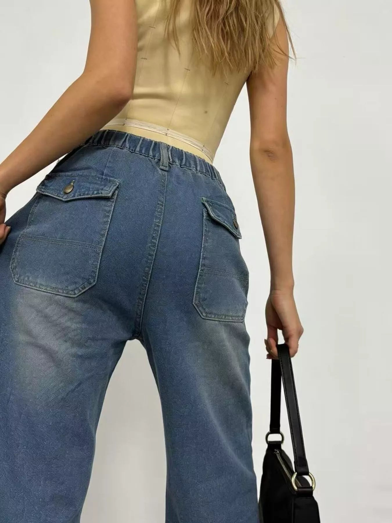 Back view of Wide Leg Contrast Stitching Jeans in high-waisted blue denim with relaxed fit and two back pockets