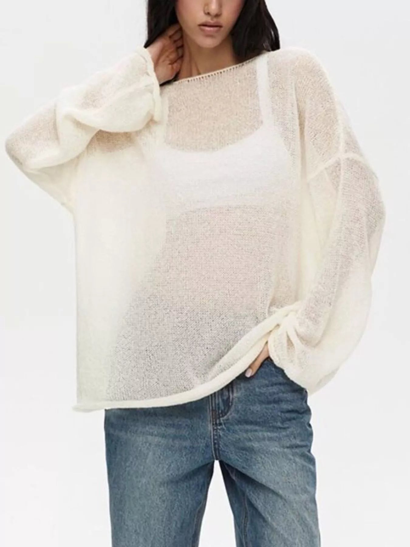 Cream-colored sheer knit boat neck dropped shoulder sweater with loose fit and voluminous sleeves