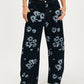 Printed wide leg jeans in black denim with light blue floral pattern