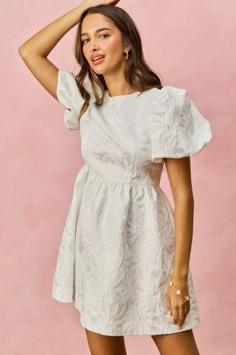 White textured mini dress with puff sleeves and floral jacquard