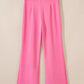 Bright pink high-waisted bootcut pants with pleated waistband